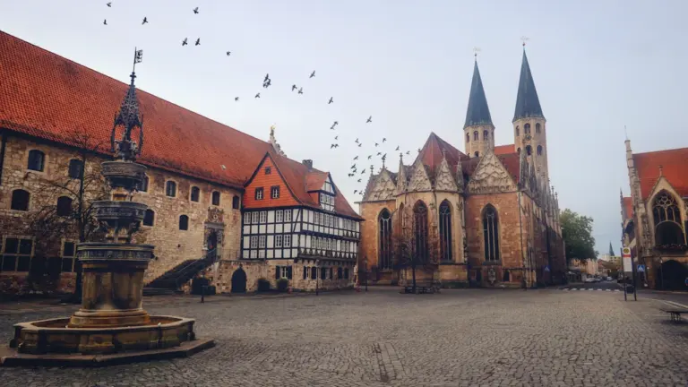 Historischer Marktplatz mit Kirche und Fachwerkhaus in einer deutschen Stadt bei Tageslicht.