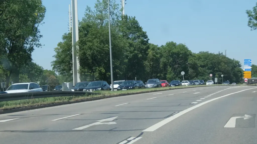 Stau auf einer Autobahn bei Sonnenuntergang mit zahlreichen Fahrzeugen in einer Schlange.